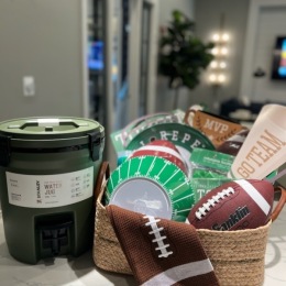 Enter our Fall Football Giveaway sports gift basket on a table
