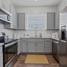 a kitchen with grey cabinets