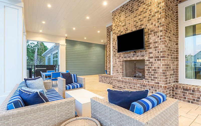 Large outdoor lounge with seating adjacent to the pool 